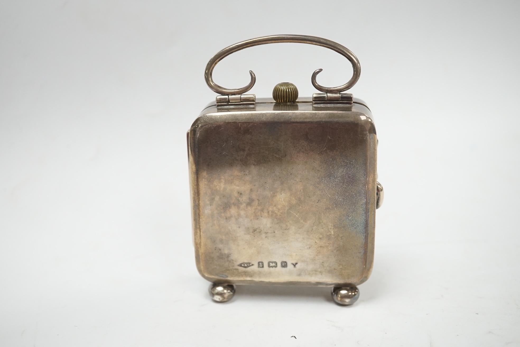 An Edwardian silver travelling pocket watch case, Birmingham, 1904, on bun feet, containing a Swiss white metal open face pocket watch. Condition - fair